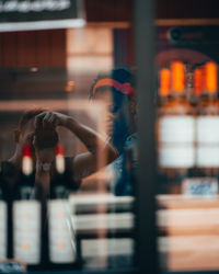 Side view of woman standing against blurred background