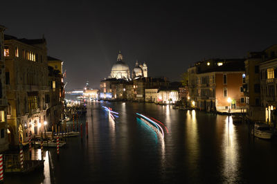 Santa maria della salute by grand canal against sky at night
