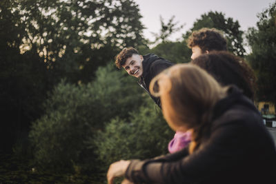 Playful boy having fun with friends at sunset