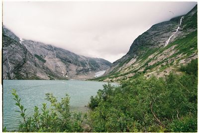 Scenic view of lake in forest against sky