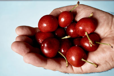 Close-up of hand holding strawberries