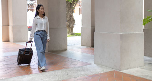 Woman with umbrella walking on floor