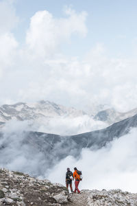 Hikers walking together on top of the mountain edge