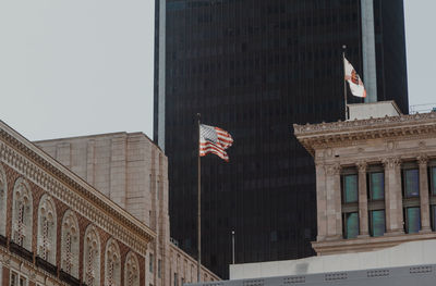 Low angle view of flags against buildings