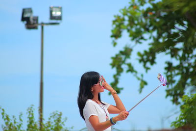 Low angle view of person holding umbrella