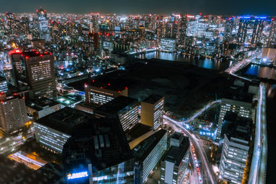 High angle view of illuminated city buildings at night