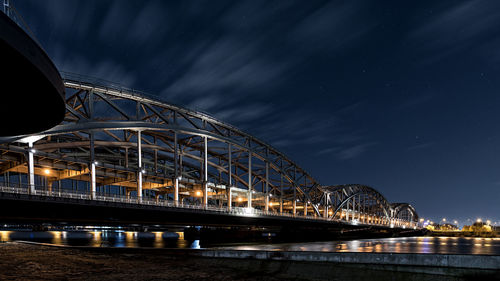 Low angle view of suspension bridge at night