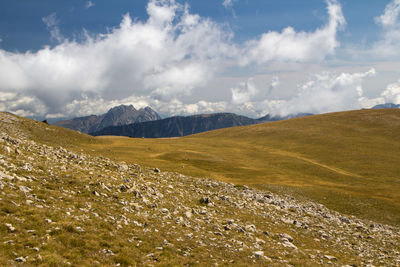 Scenic view of landscape with far mountain peak against sky