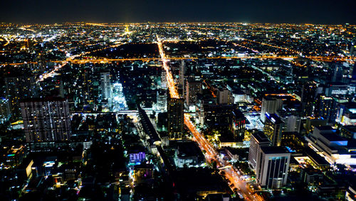 High angle view of illuminated city buildings at night