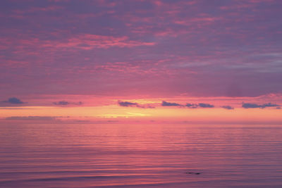 Scenic view of sea against romantic sky at sunset