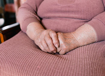 Close-up of woman hand on carpet at home