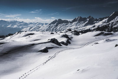 Scenic view of snowcapped mountains against sky