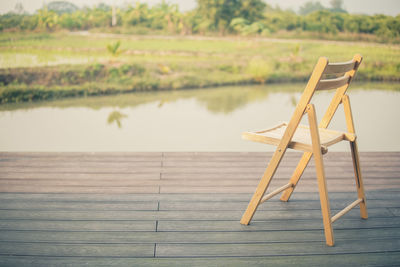 Wooden table by lake