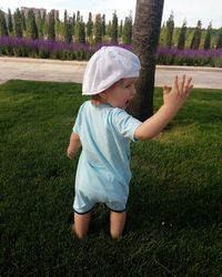 Cute boy standing on field