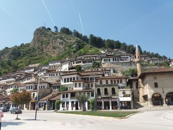 Buildings in town against clear sky