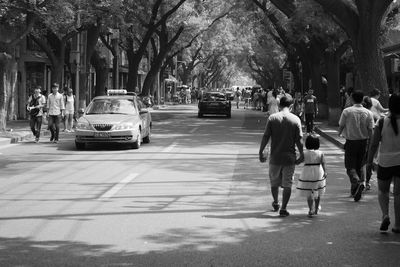 People on road in city