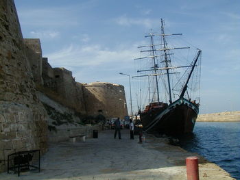 Ship on moored on harbor by castle