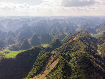 Scenic view of mountain range against cloudy sky