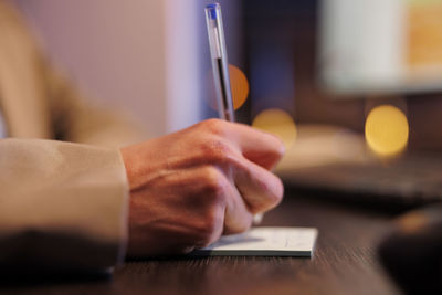 Midsection of businessman working on table