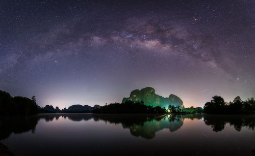 Scenic view of lake against sky at night