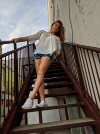 Low angle view of woman standing on staircase