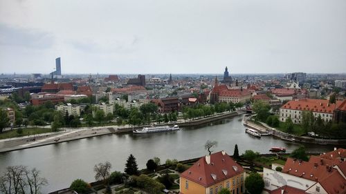 High angle view of buildings and river against sky