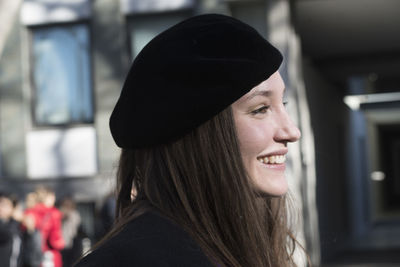 Portrait of beautiful young woman in hat