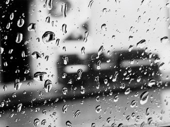 Full frame shot of wet glass window in rainy season