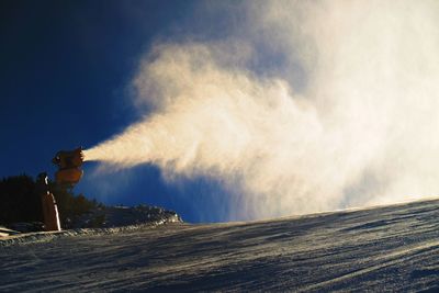 Snow cannon making fresch powder snow. mountain ski resort and winter calm mountain landscape.