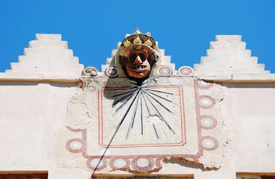 Low angle view of sculpture against building