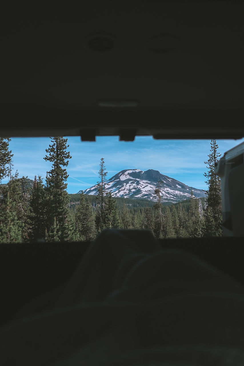 SCENIC VIEW OF SNOWCAPPED MOUNTAINS AGAINST SKY SEEN THROUGH CAR