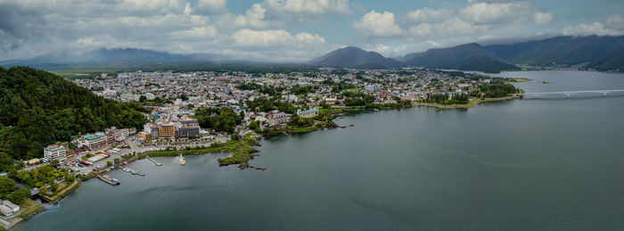 Panoramic view of buildings and mountains against sky