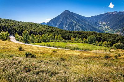 Scenic view of mountains against blue sky