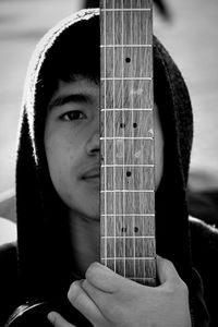 Close-up portrait of man holding guitar