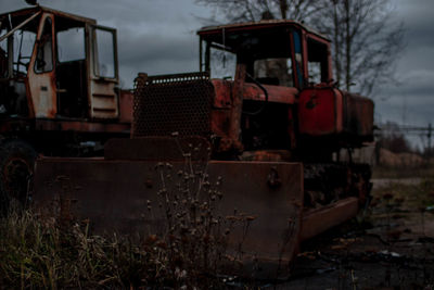 Abandoned truck on field against sky