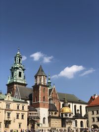 Low angle view of buildings against blue sky