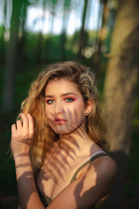 Portrait of beautiful woman lying on land