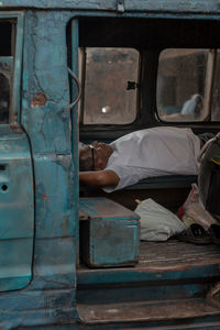 Man lying in abandoned van