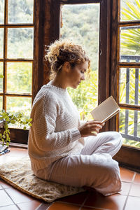 Young woman using laptop while sitting at home