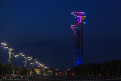 Low angle view of illuminated ferris wheel at night