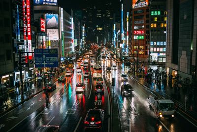 Vehicles on road in city at night