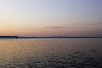 Scenic view of sea against sky at sunset