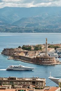 High angle view of townscape by sea against sky