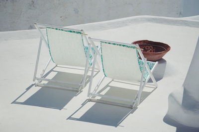 High angle view of empty chairs and table