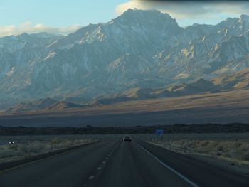 Highway against mountain range