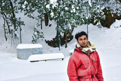 Portrait of young man in snow