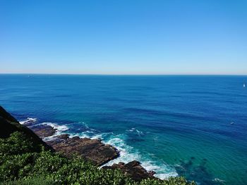 Scenic view of sea against clear blue sky