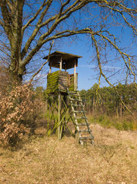 Built structure on field against trees in forest