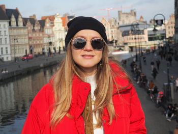 Portrait of smiling woman standing in city