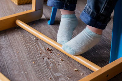 Low section of man working on wooden floor